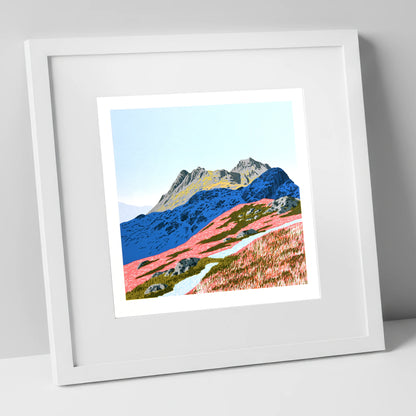 Langdale Pikes in Vivid Coral lake district fell art print in white frame