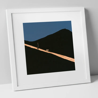 Dog Walker on Sunlit Skiddaw gifts for dog walkers art print in white frame