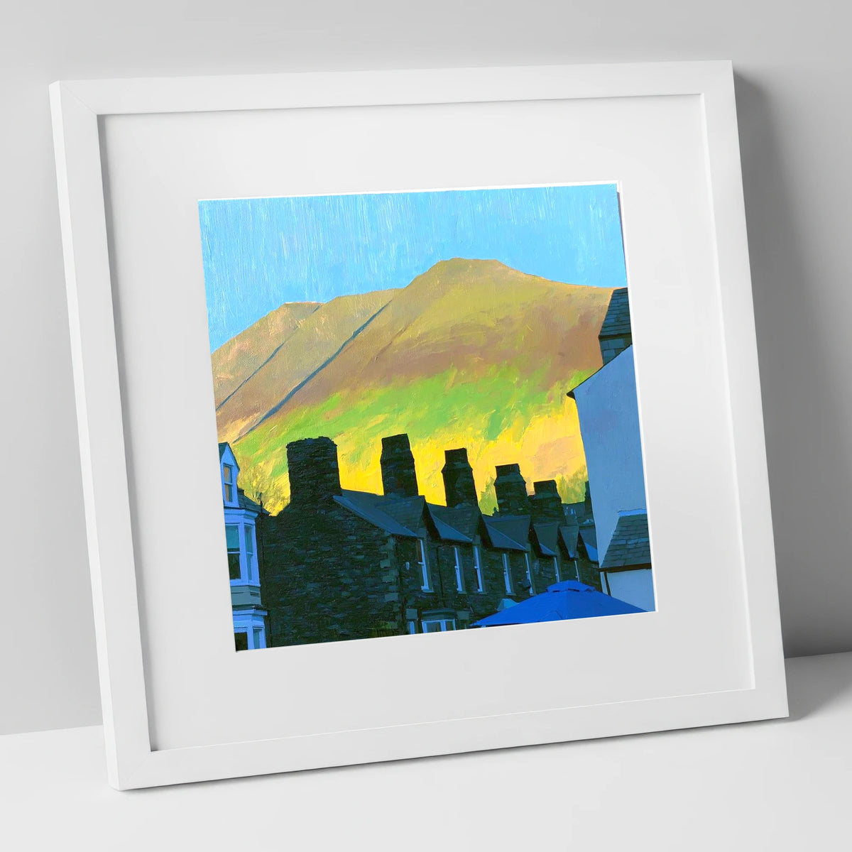 Keswick Chimneys and Sunlit Skiddaw lake district village art print in white frame