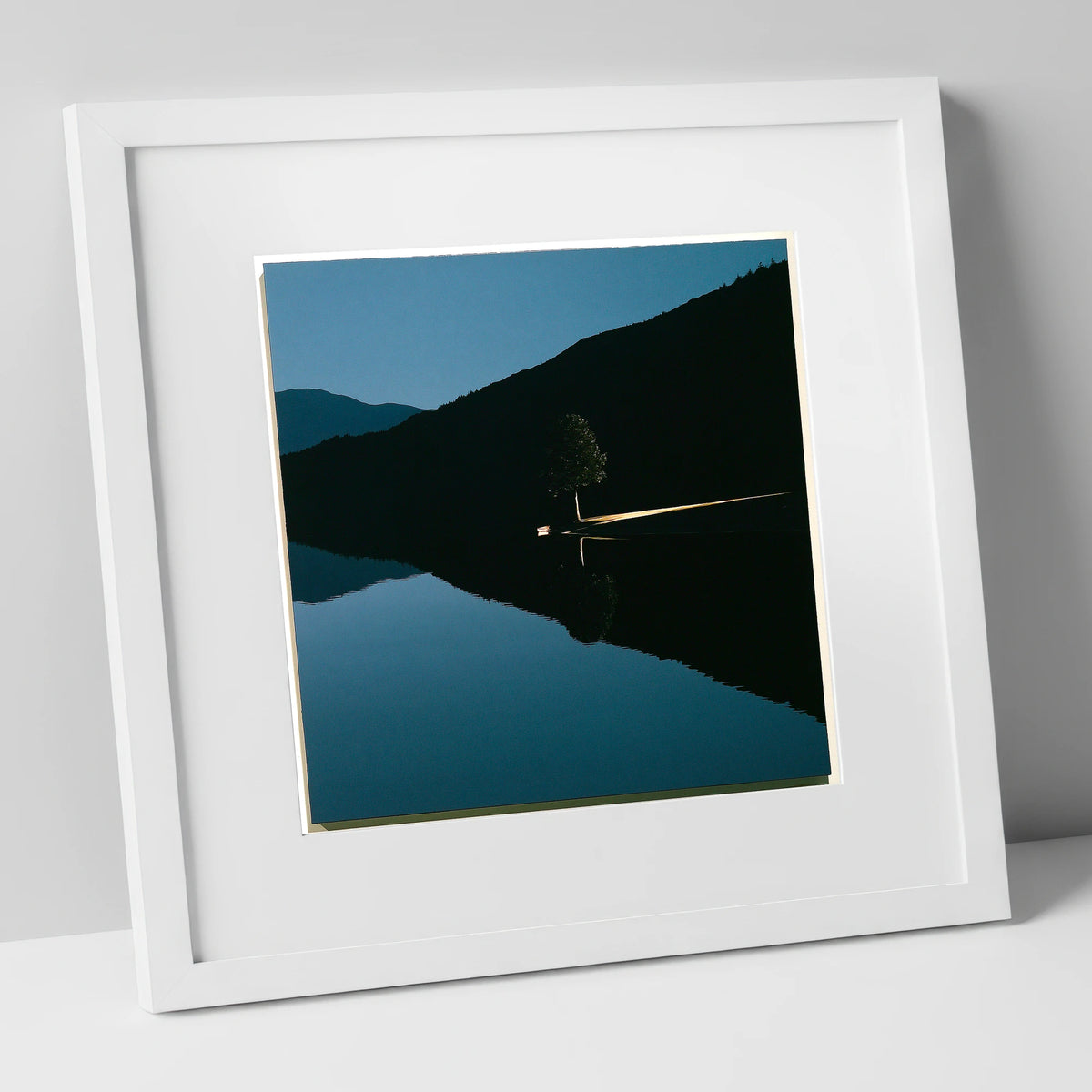 Illuminated Shore on Calm Lake lake district lake art print in white frame