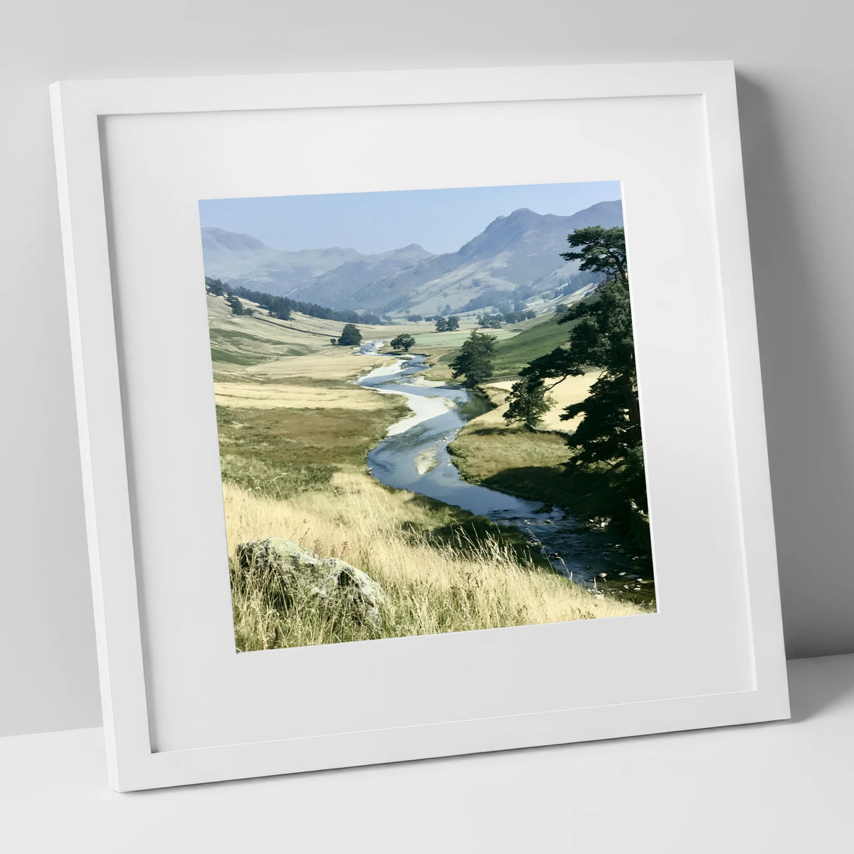 Winding River Beneath Hazy Fells lake district waterfall art print in white frame