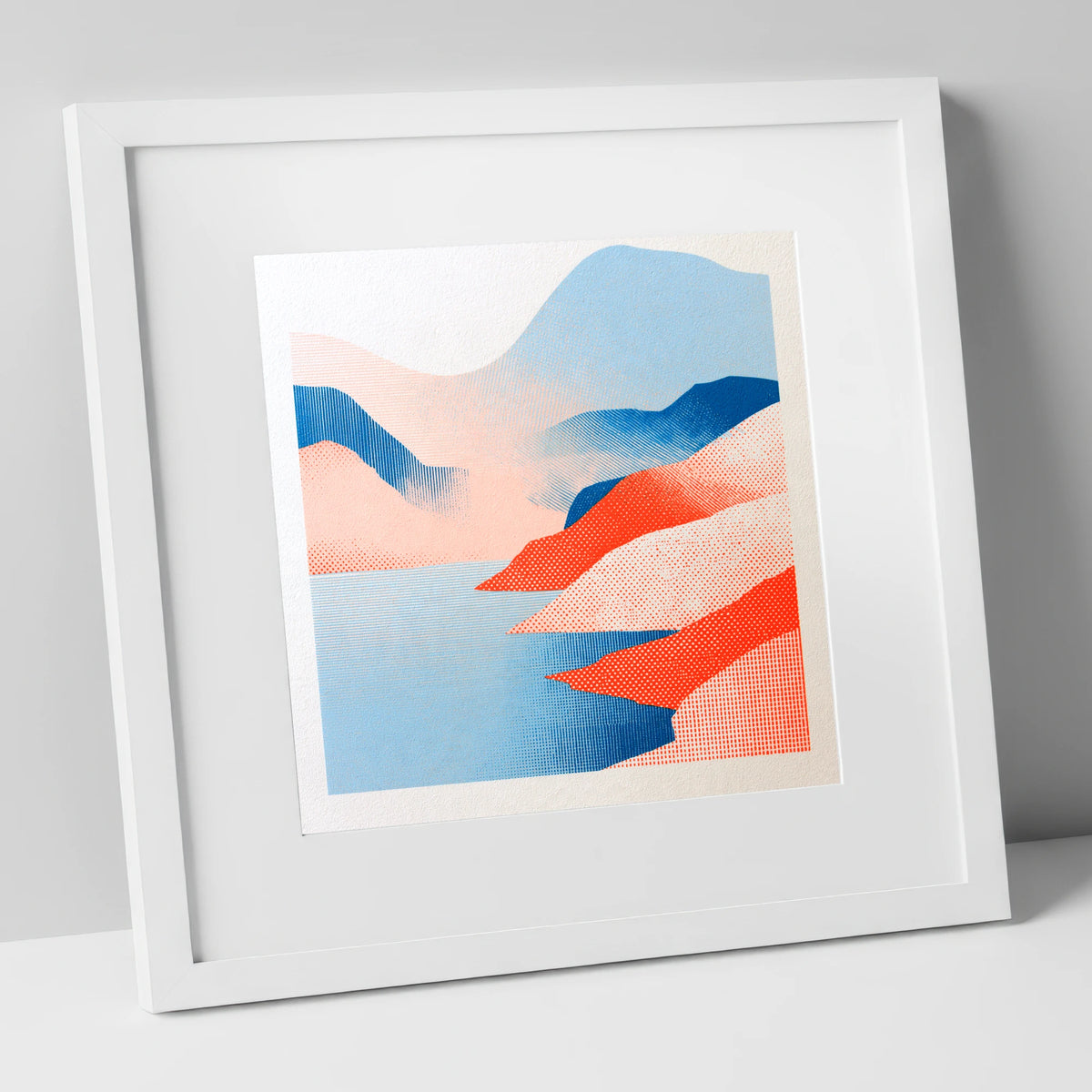 Graphic Buttermere in Coral and Blue lake district lake art print in white frame