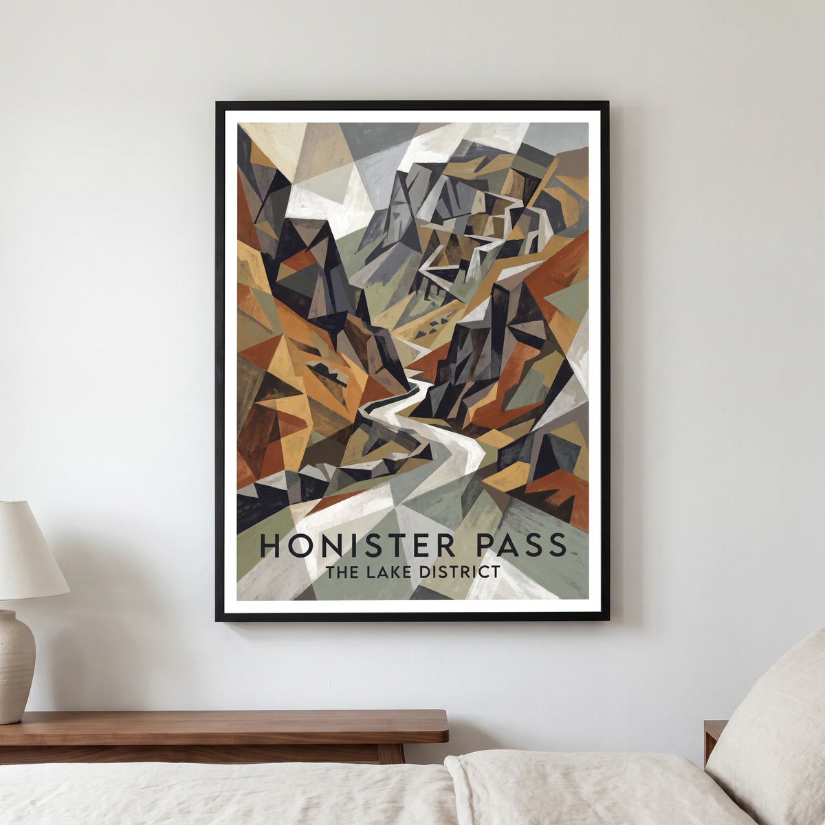 Honister Pass travel poster in a black frame, hanging in a bedroom3
