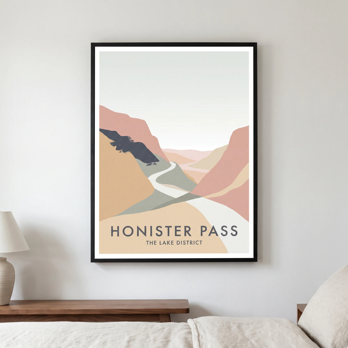 Honister Pass travel poster in a black frame, hanging in a bedroom3