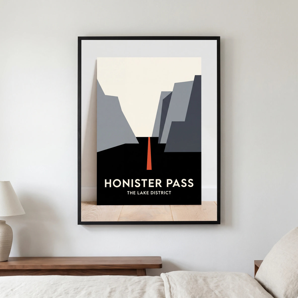 Honister Pass travel poster in a black frame, hanging in a bedroom3