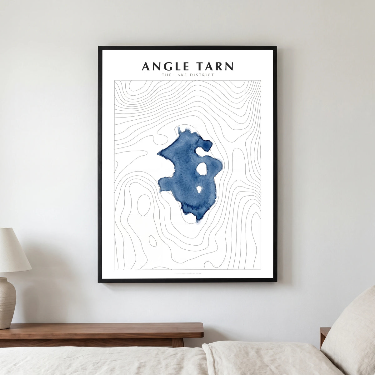 Angle Tarn lake map poster in a black frame, hanging in a bedroom
