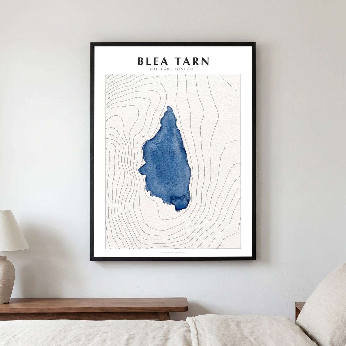 Blea Tarn lake map poster in a black frame, hanging in a bedroom