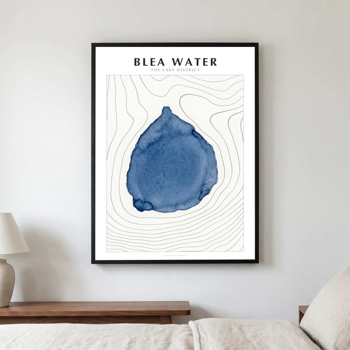 Blea Water lake map poster in a black frame, hanging in a bedroom