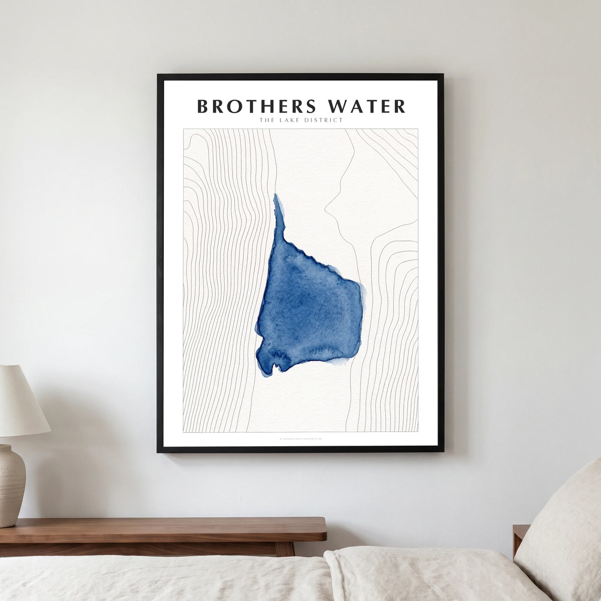 Brothers Water lake map poster in a black frame, hanging in a bedroom