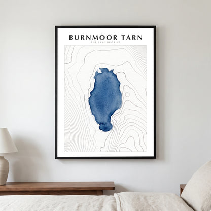 Burnmoor Tarn lake map poster in a black frame, hanging in a bedroom