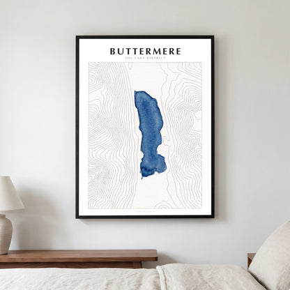 Buttermere lake map poster in a black frame, hanging in a bedroom