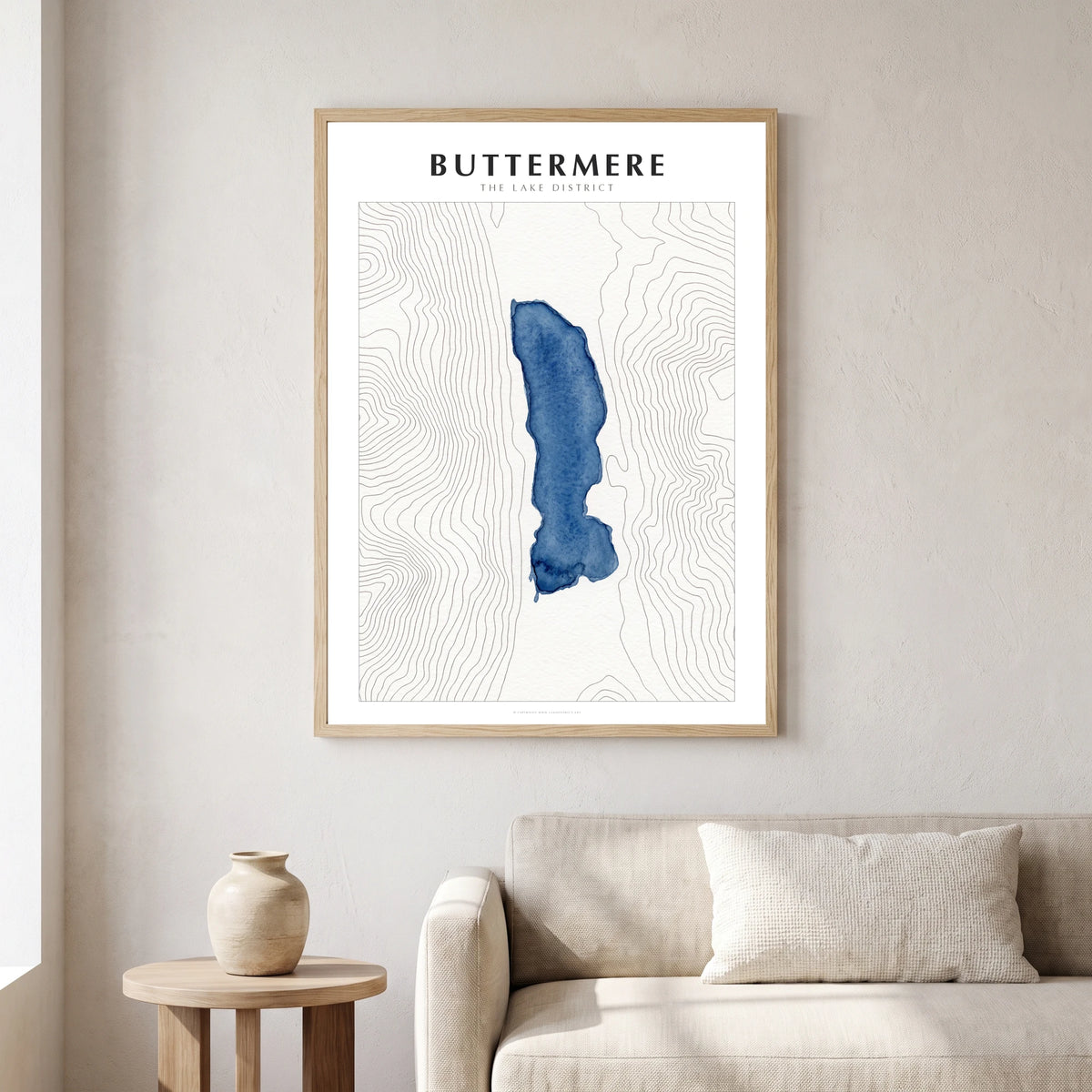 Buttermere lake map poster in a natural frame, hanging in a living