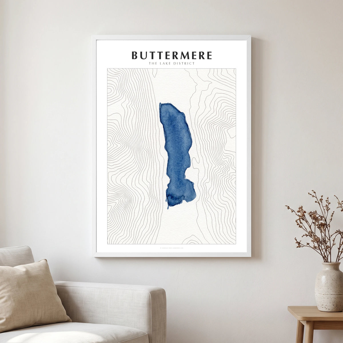 Buttermere lake map poster in a white frame, hanging in a living