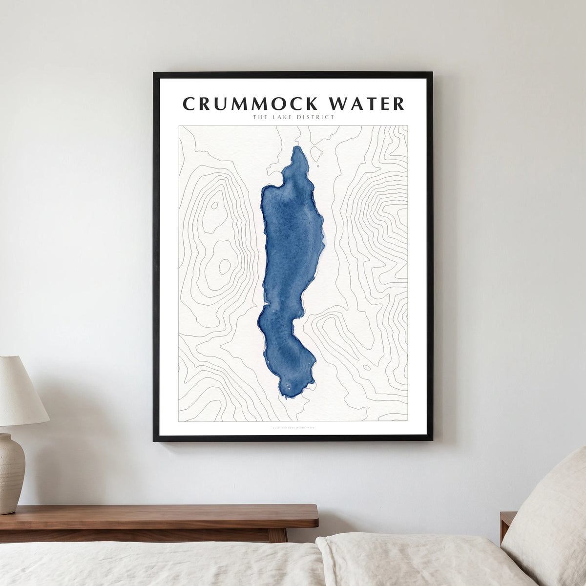 Crummock Water lake map poster in a black frame, hanging in a bedroom