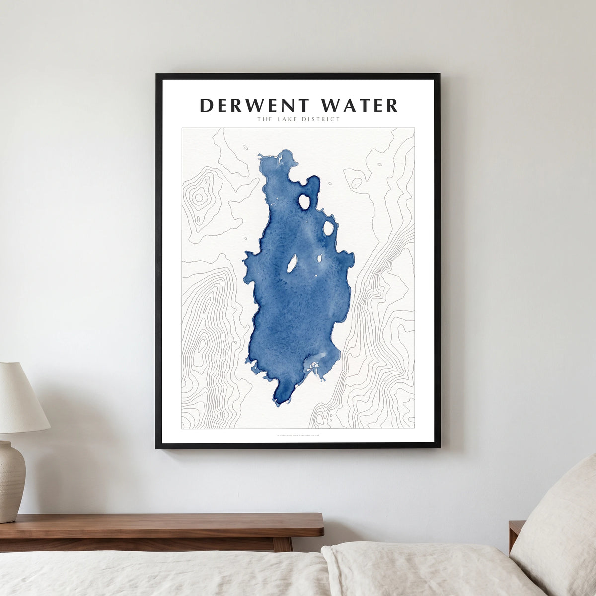Derwent Water lake map poster in a black frame, hanging in a bedroom