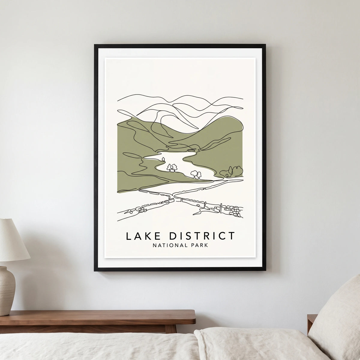 Lake District travel poster in a black frame, hanging in a bedroom3