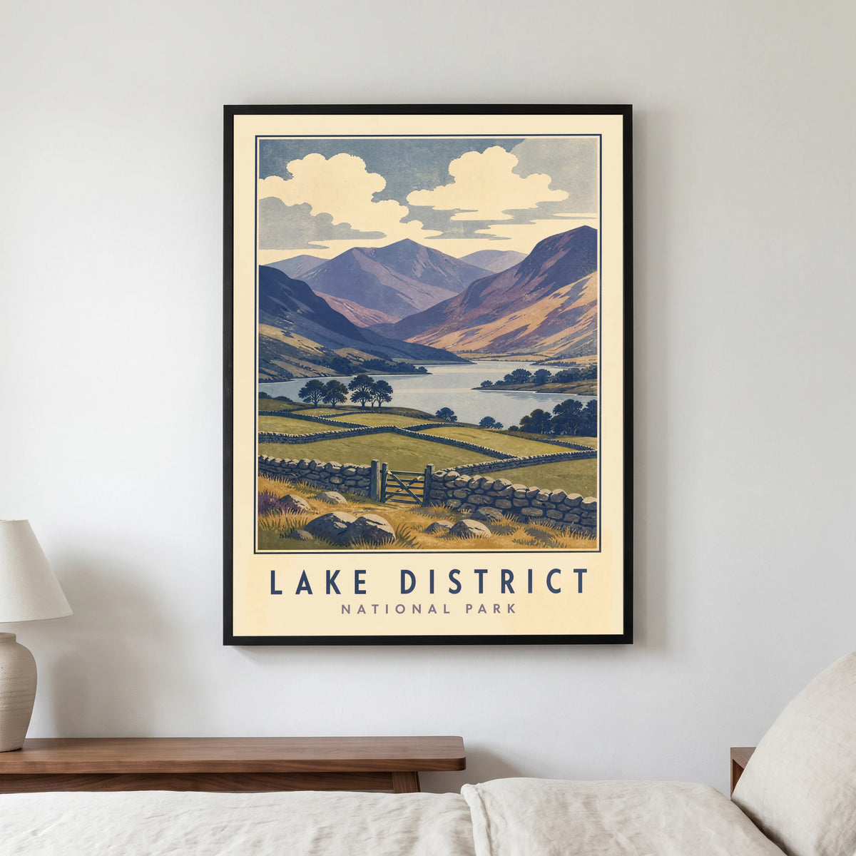 Lake District travel poster in a black frame, hanging in a bedroom3