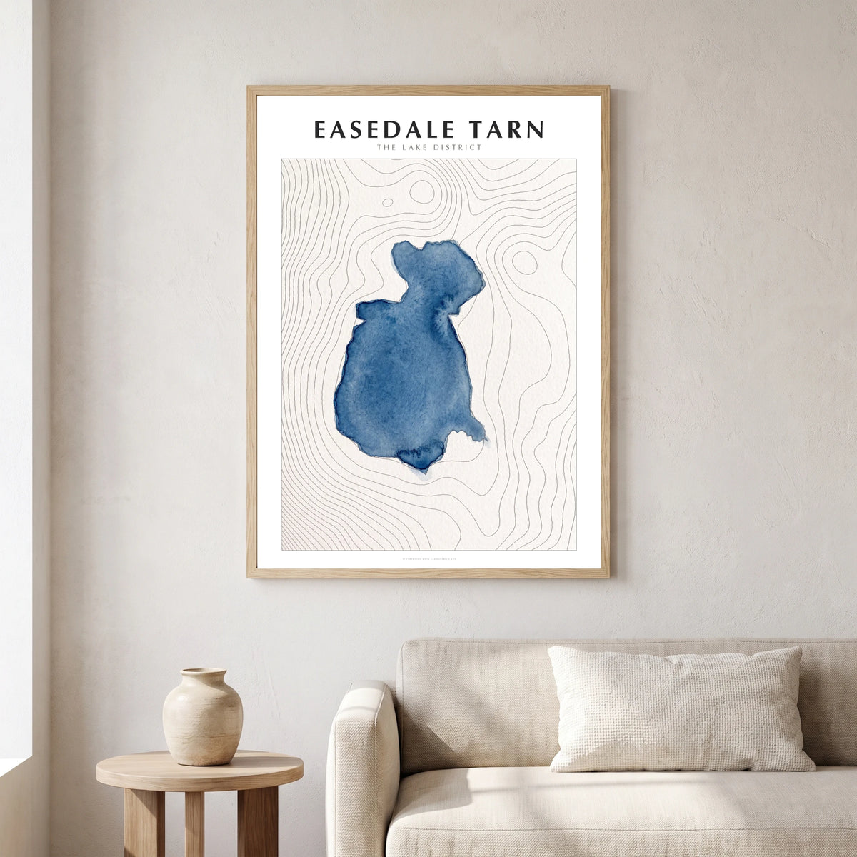 Easedale Tarn lake map poster in a natural frame, hanging in a living