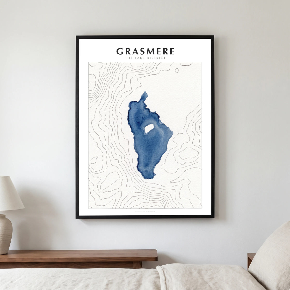 Grasmere lake map poster in a black frame, hanging in a bedroom