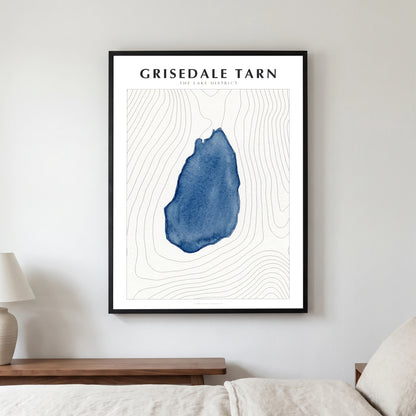 Grisedale Tarn lake map poster in a black frame, hanging in a bedroom
