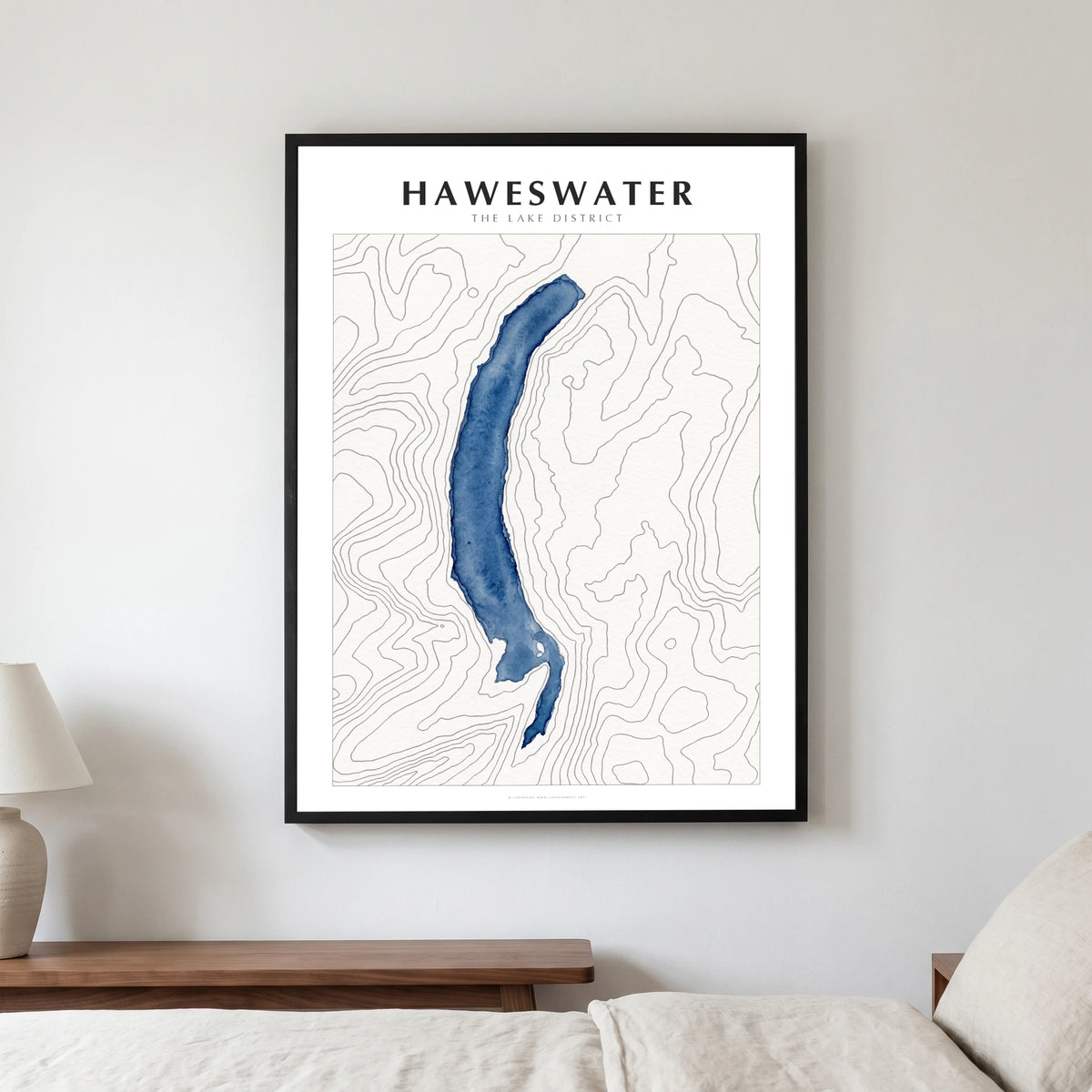 Haweswater lake map poster in a black frame, hanging in a bedroom