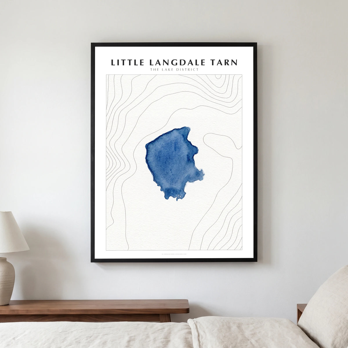 Little Langdale Tarn lake map poster in a black frame, hanging in a bedroom