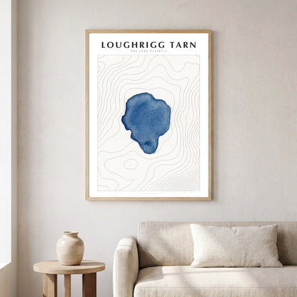 Loughrigg Tarn lake map poster in a natural frame, hanging in a living