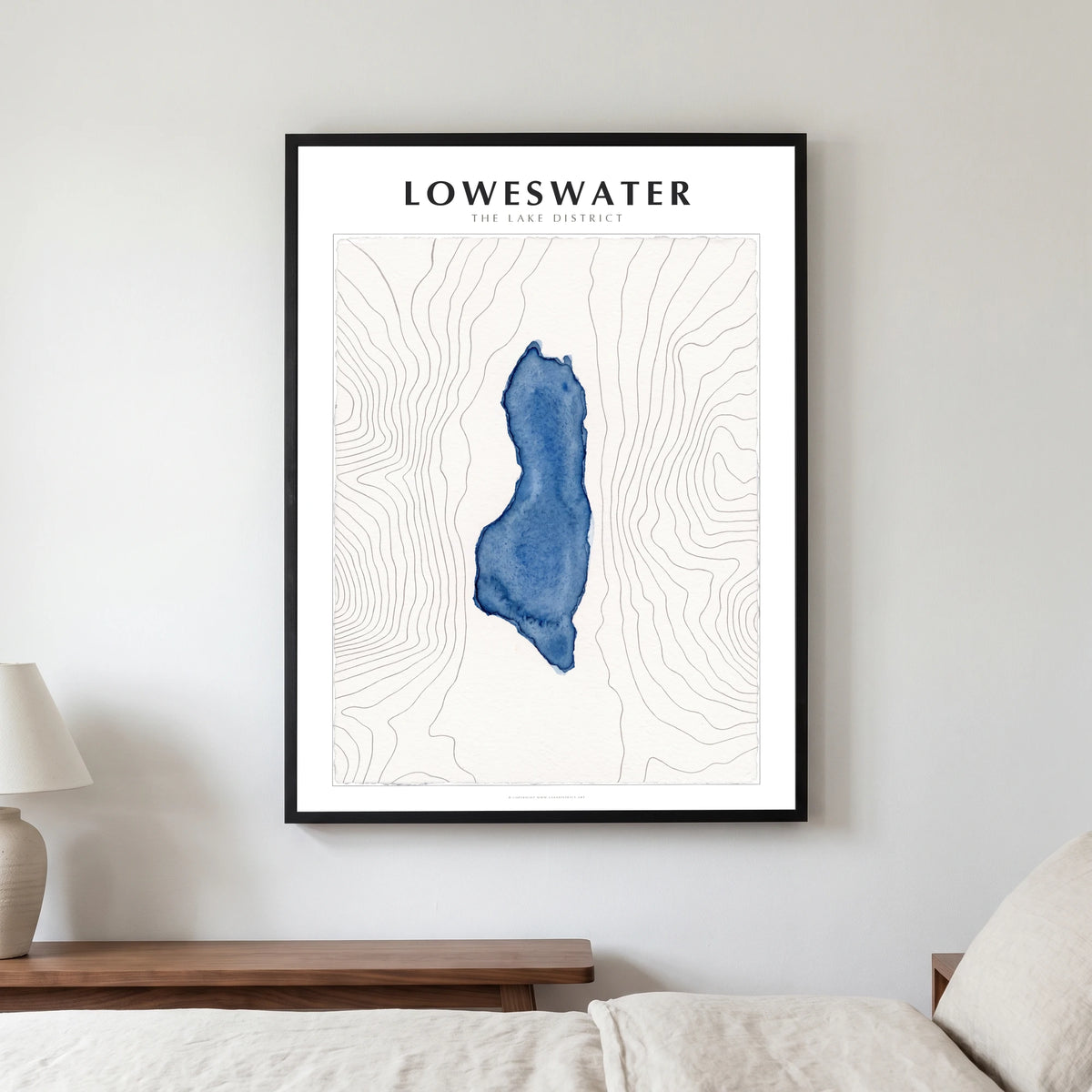 Loweswater lake map poster in a black frame, hanging in a bedroom