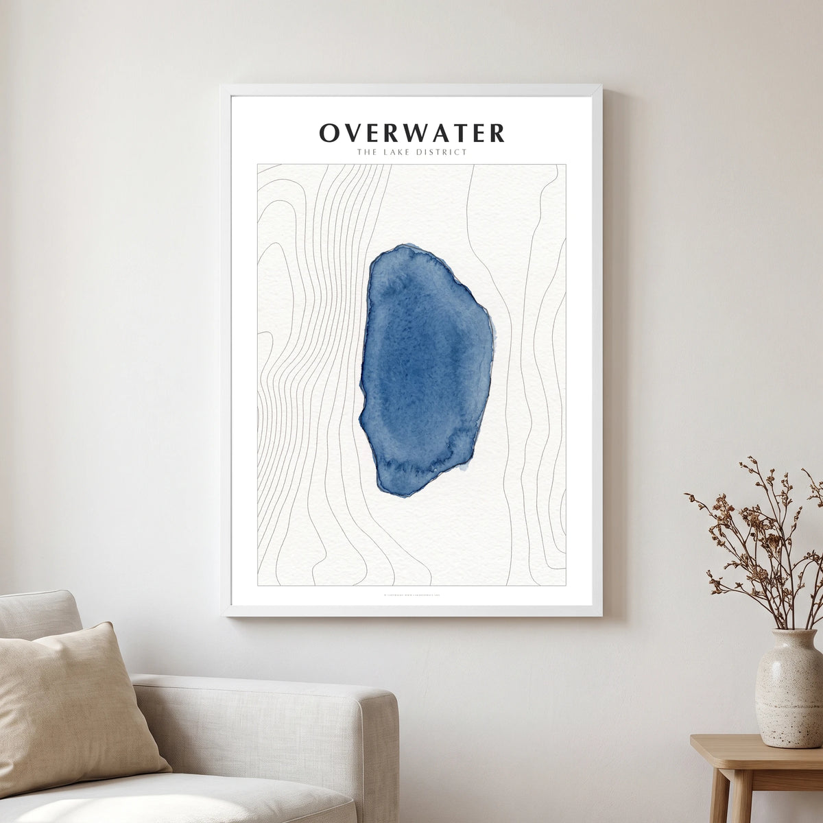 Overwater lake map poster in a white frame, hanging in a living