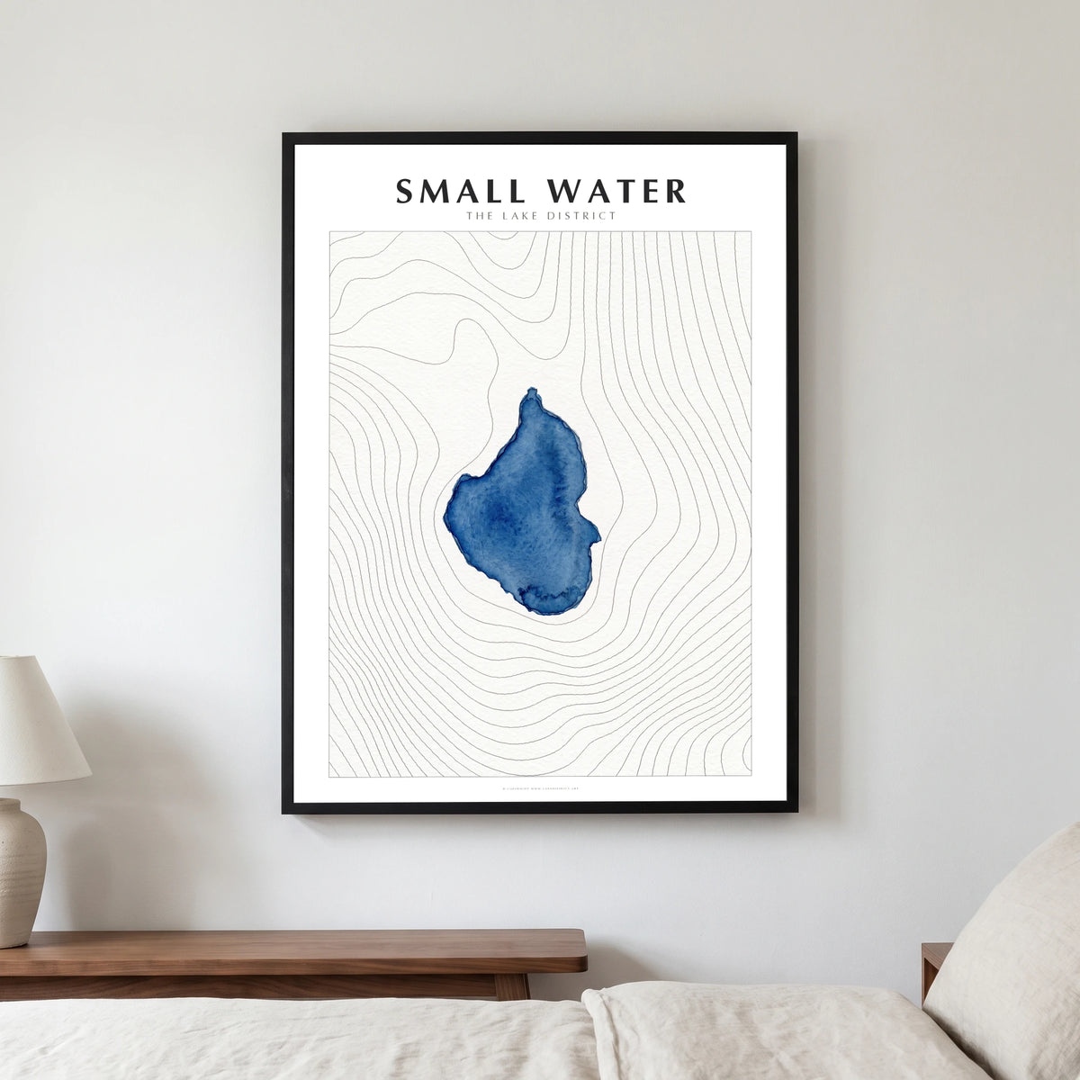 Small Water lake map poster in a black frame, hanging in a bedroom