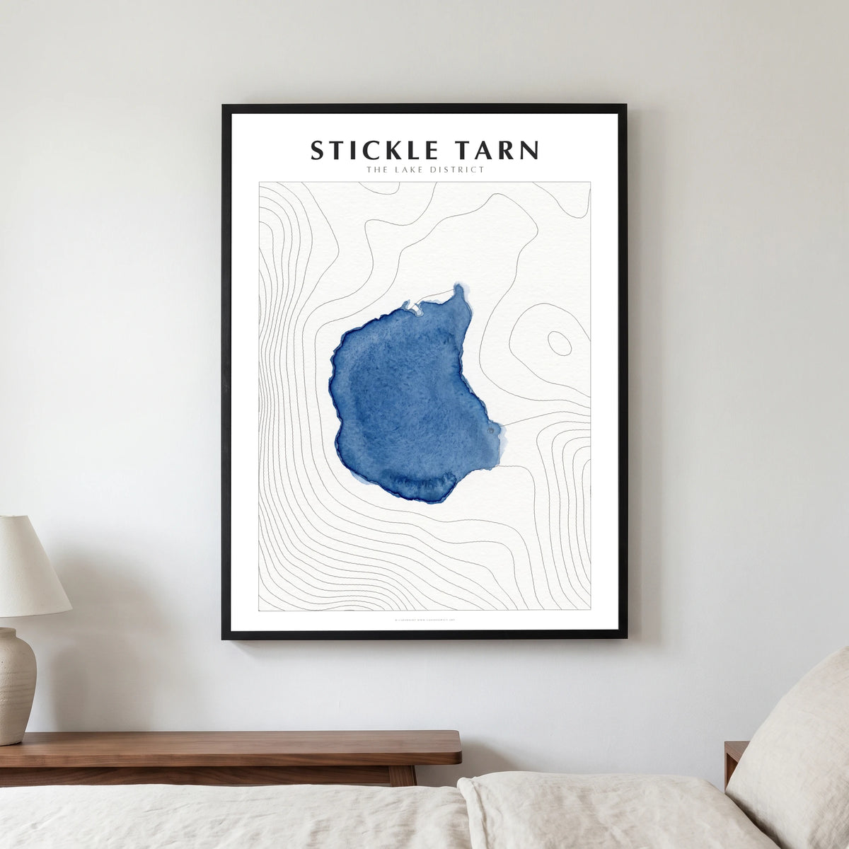 Stickle Tarn lake map poster in a black frame, hanging in a bedroom