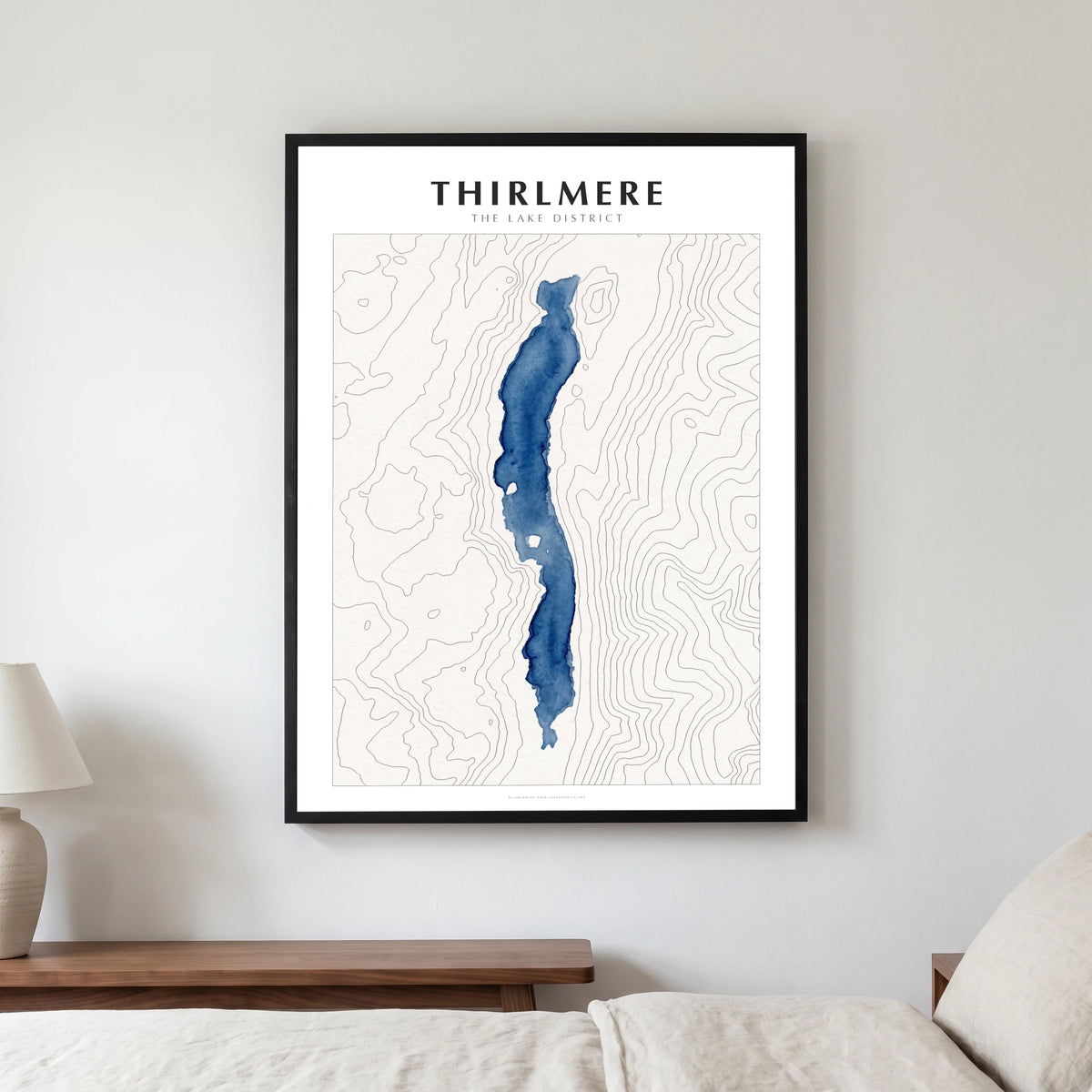 Thirlmere lake map poster in a black frame, hanging in a bedroom