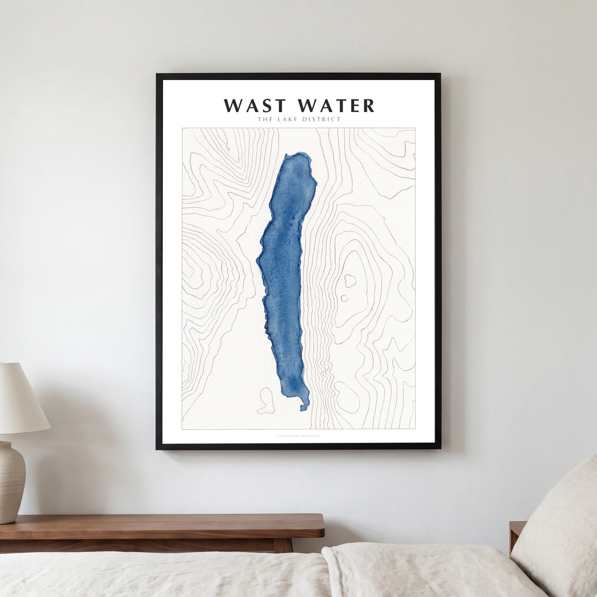 Wast Water lake map poster in a black frame, hanging in a bedroom