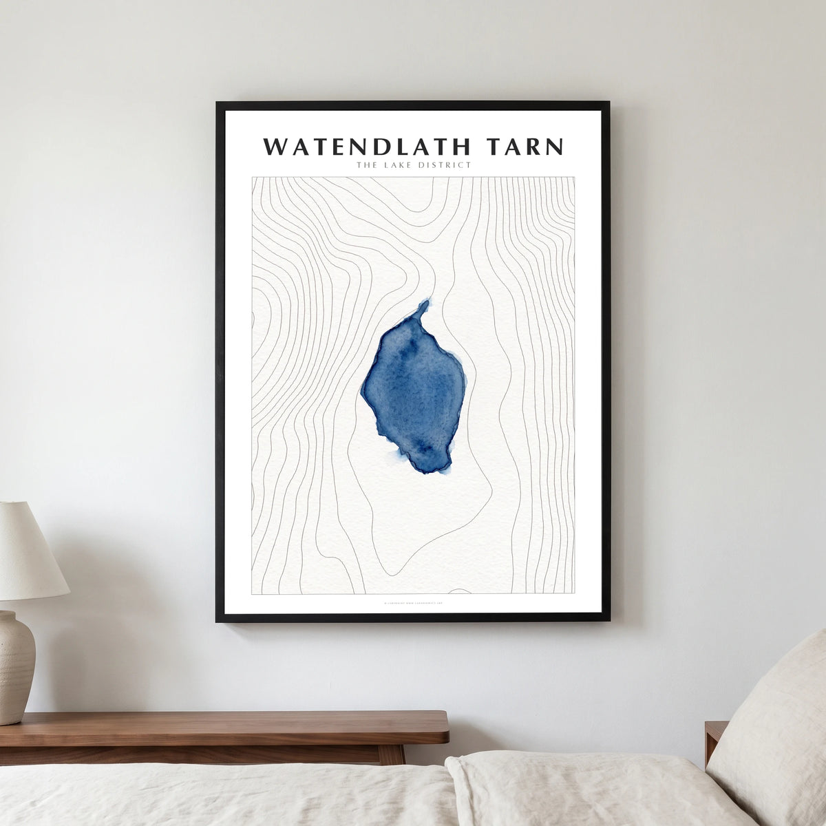 Watendlath Tarn lake map poster in a black frame, hanging in a bedroom