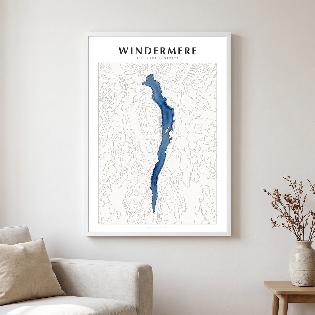 Windermere lake map poster in a white frame, hanging in a living