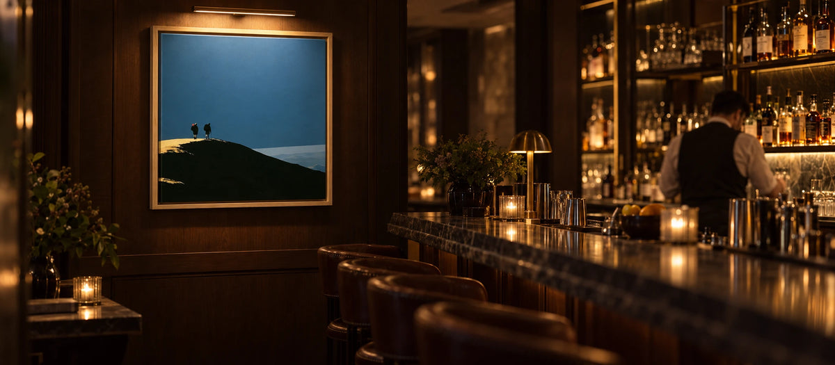 A lit Lake District canvas above the bar in a hotel bar at night