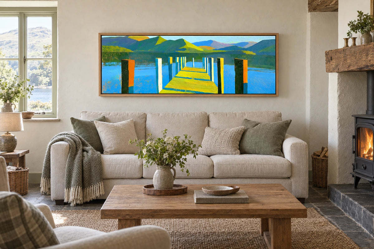 A framed Derwentwater painting hanging in holiday cottage