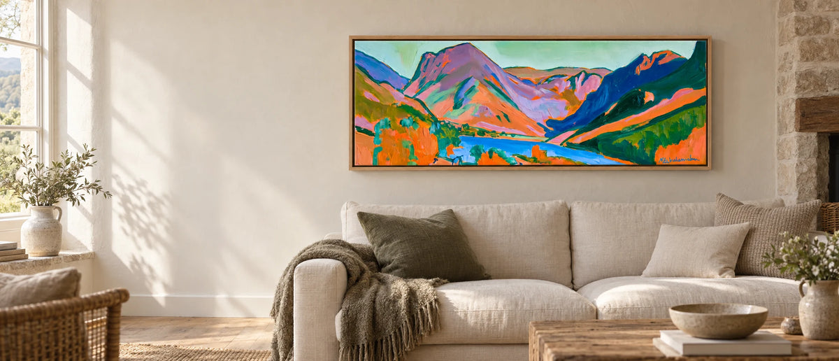 Vibrant Sunset over Buttermere Valley — 152cm float-framed panoramic canvas above a sofa in a Lakeland cottage living room