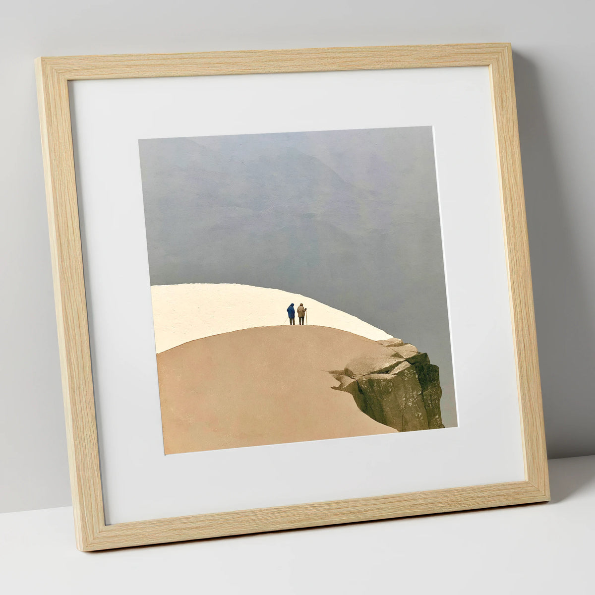 Framed art print in a natural wood frame with white mount, fell walkers on a snowy ridge