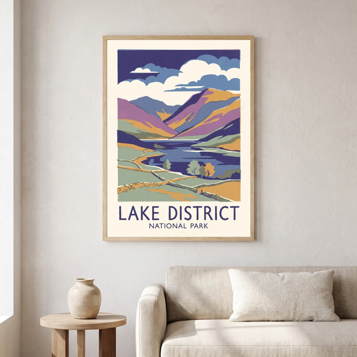 Lake District travel poster in a natural wood frame on a living room wall