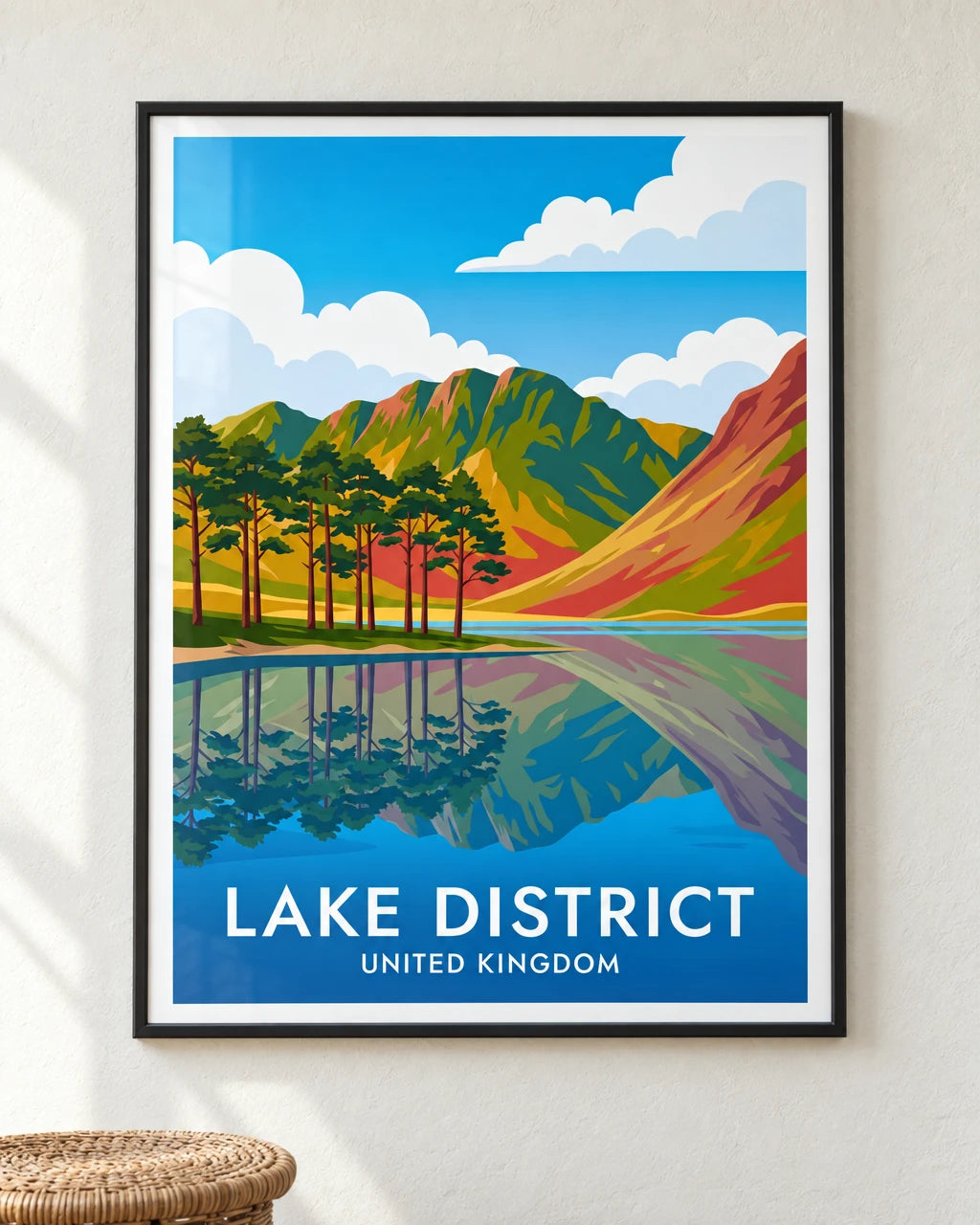 Buttermere vivid Lake District travel poster in a black frame on a plaster wall