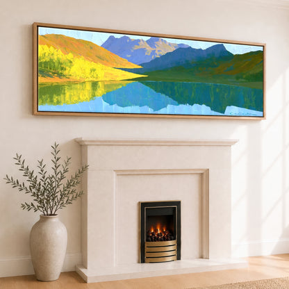 Sunlit Fells over Crummock Water Reflection Lake District Lake panoramic canvas wall art displayed above a fireplace