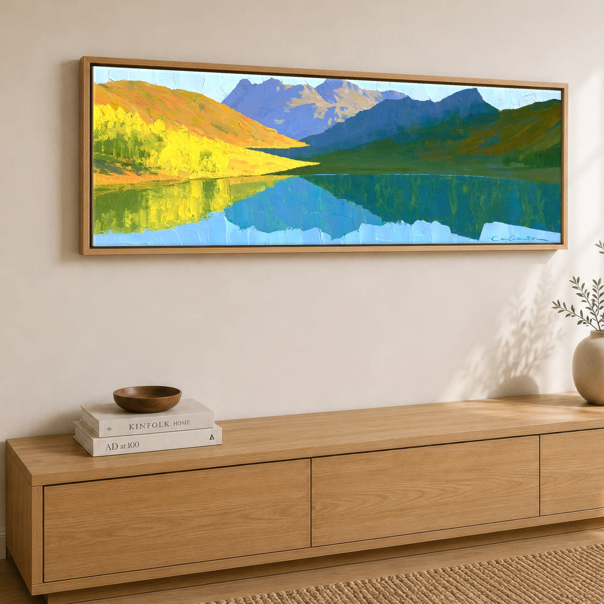 Sunlit Fells over Crummock Water Reflection Lake District Lake panoramic canvas wall art displayed above a sideboard