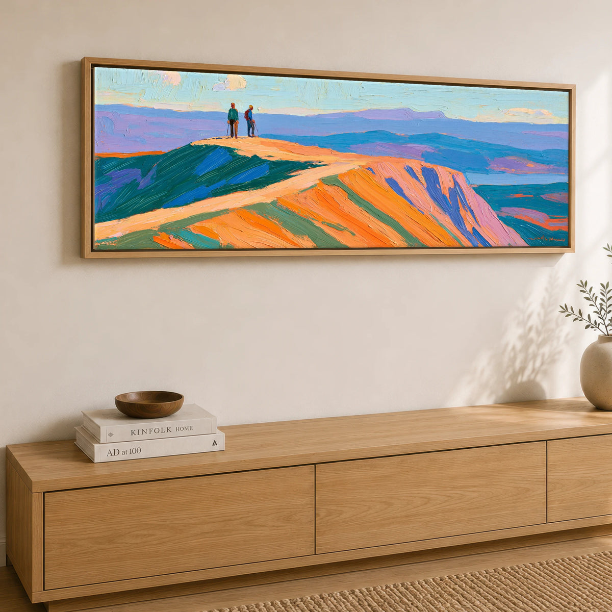 Hikers on a Radiant Fell Top Lake District Fell panoramic canvas wall art displayed above a sideboard