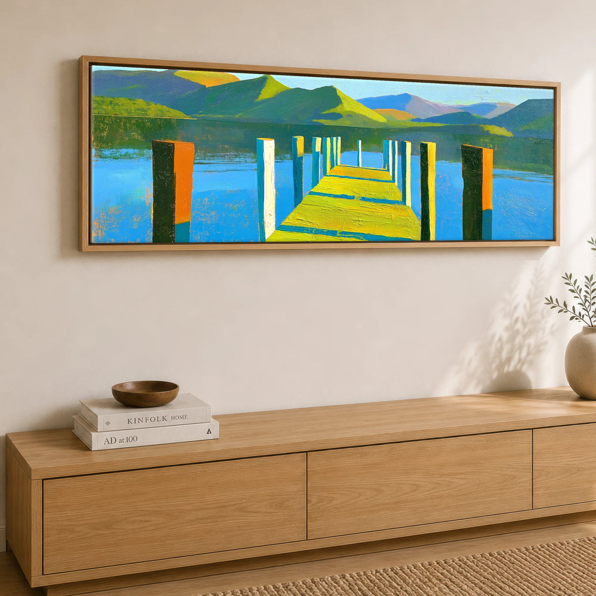 Sunlit Jetty and Vibrant Lakeland Fells Lake District Lake panoramic canvas wall art displayed above a sideboard