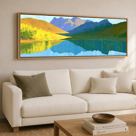 Sunlit Fells over Crummock Water Reflection Lake District Lake panoramic canvas wall art displayed above a sofa