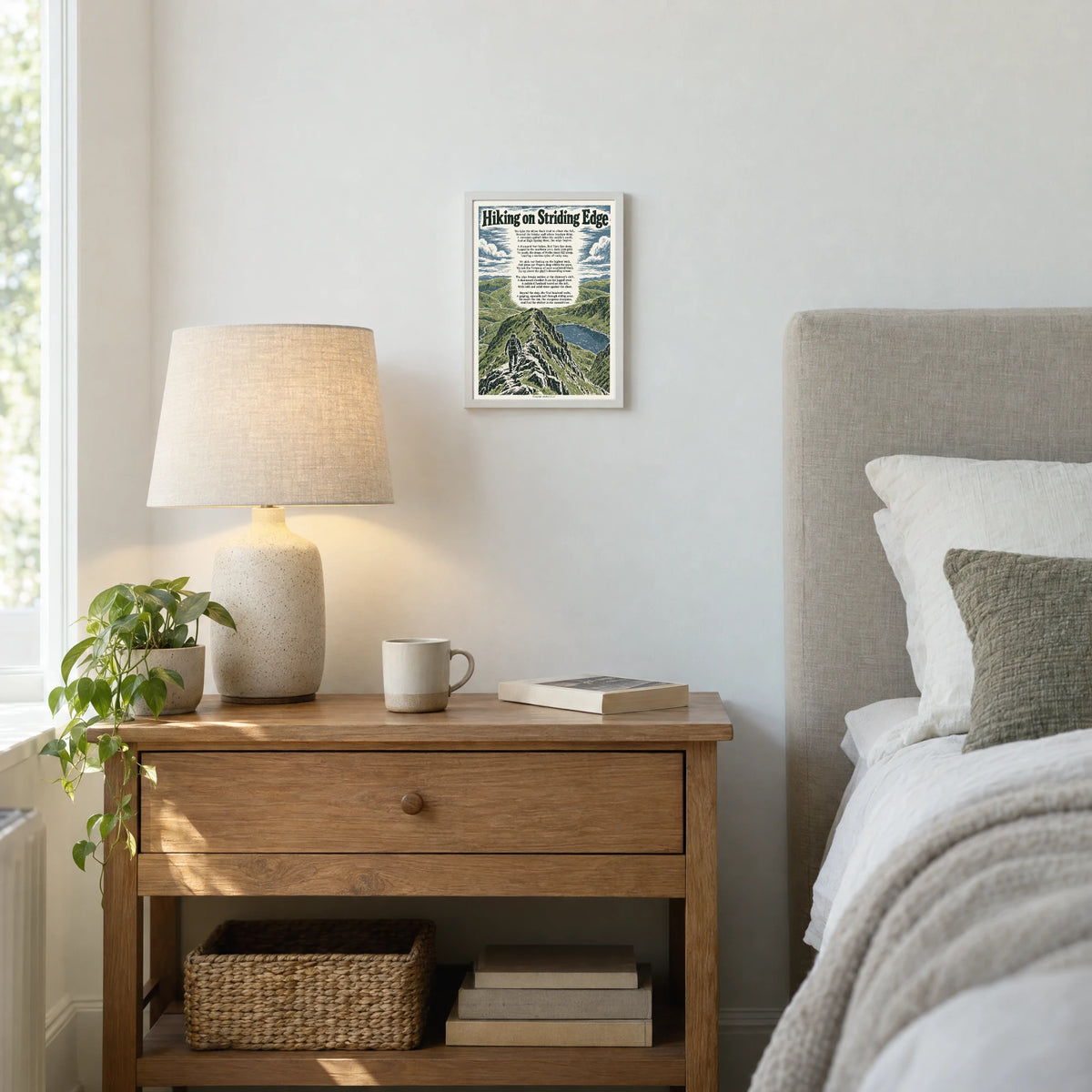 Hiking on Striding Edge poem print at A4 size, in a white frame, hanging in a bedroom