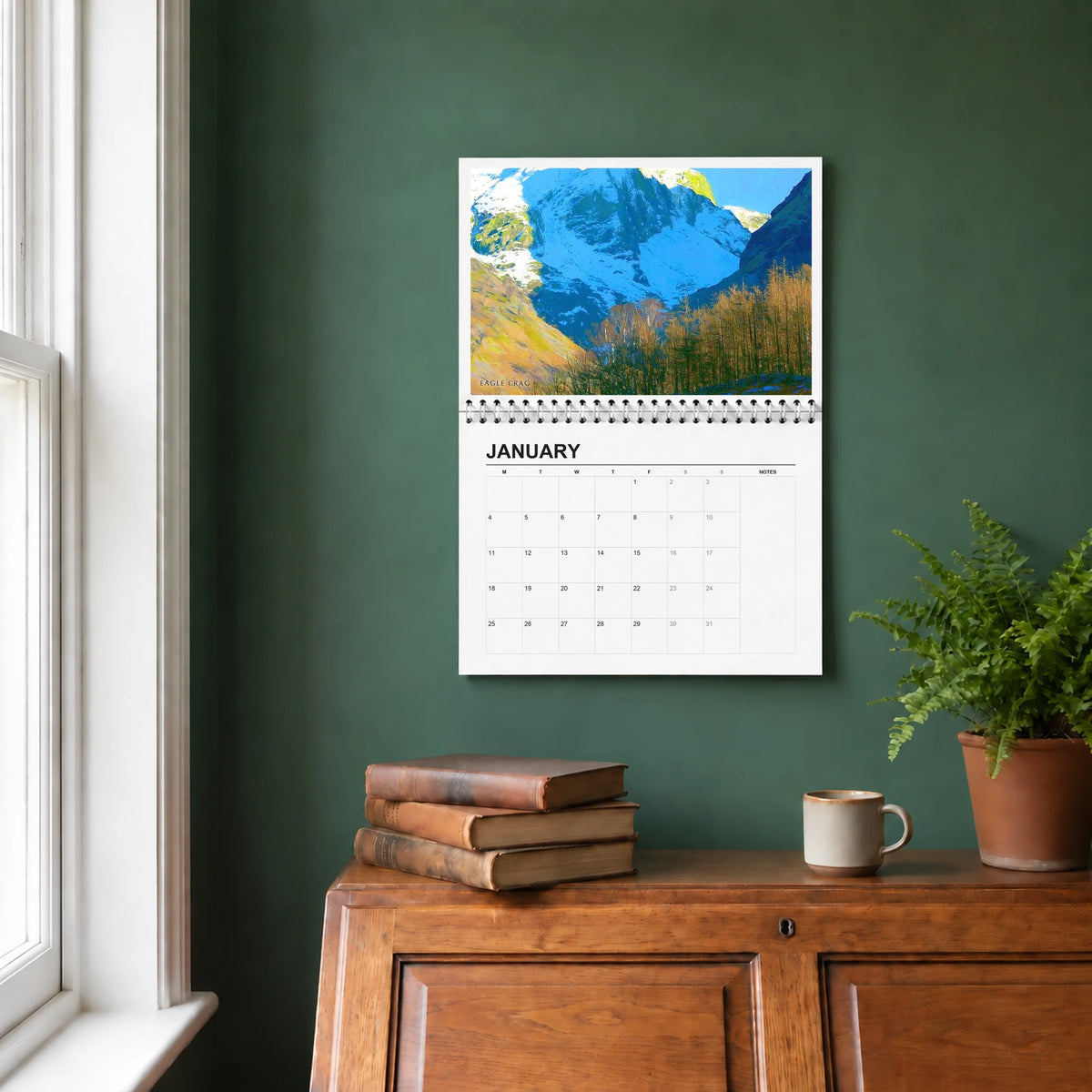 The Lake District 2027 wall calendar hanging in a study