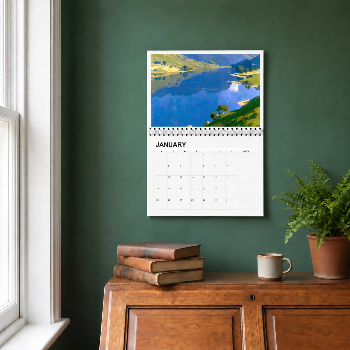 The Lakes 2027 wall calendar hanging in a study