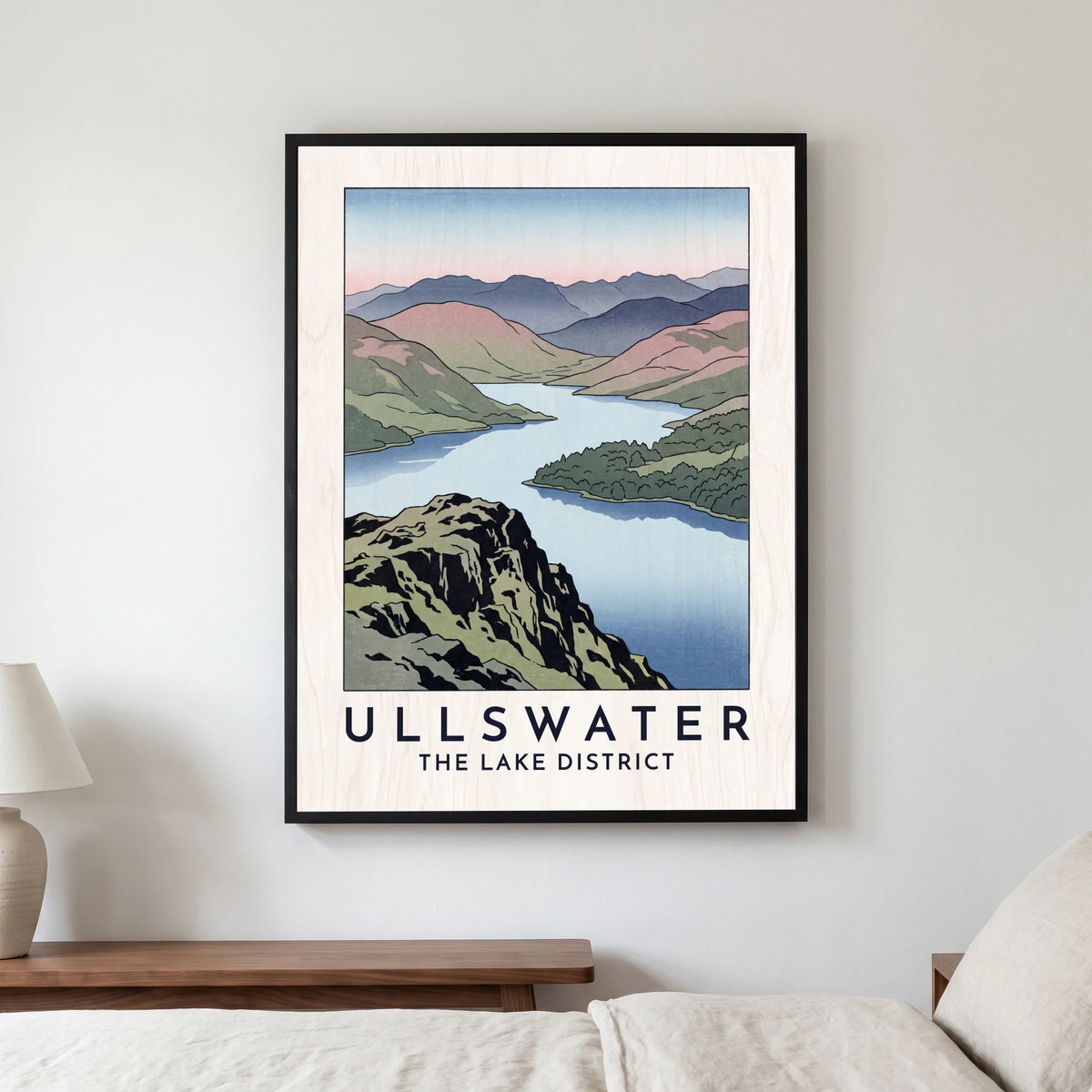 Ullswater travel poster in a black frame, hanging in a bedroom3